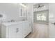 Bright bathroom with double vanity, framed mirror, and tile flooring at 1727 Cane Branch Rd., Loris, SC 29569