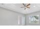 Bedroom featuring a ceiling fan, tray ceiling, and bright window at 1727 Cane Branch Rd., Loris, SC 29569