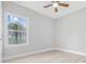 Bright bedroom features a ceiling fan, light hardwood floors and view of lush tropical foliage at 1727 Cane Branch Rd., Loris, SC 29569