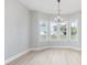 Dining area featuring a modern chandelier and large windows overlooking the yard and letting in lots of light at 1727 Cane Branch Rd., Loris, SC 29569