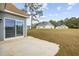 Back exterior of a home showing large glass sliding doors to patio at 1727 Cane Branch Rd., Loris, SC 29569