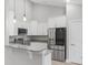 Bright kitchen featuring white cabinets, stainless steel appliances and granite countertops with a bar area at 1727 Cane Branch Rd., Loris, SC 29569