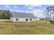 Spacious backyard featuring a home with a neutral exterior and a well-maintained lawn at 1900 Blue Bird Rd., Loris, SC 29569