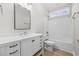 Clean bathroom featuring a white vanity, a tub with shower, and a window at 1900 Blue Bird Rd., Loris, SC 29569