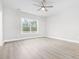 Bright bedroom featuring a ceiling fan, large window, and neutral walls at 1900 Blue Bird Rd., Loris, SC 29569