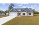Charming home with a two-car garage, gray roof, and blue and beige siding, set on a well-maintained lawn at 1900 Blue Bird Rd., Loris, SC 29569