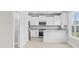 Modern kitchen with white cabinetry, stainless steel appliances, and bright natural light at 1900 Blue Bird Rd., Loris, SC 29569