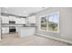 Modern kitchen featuring white cabinets, granite countertops, stainless steel appliances, and natural light at 1900 Blue Bird Rd., Loris, SC 29569