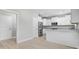 Well-lit kitchen with stainless steel appliances, white cabinets, and granite countertops at 1900 Blue Bird Rd., Loris, SC 29569