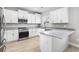 Bright modern kitchen featuring white cabinets, granite countertops, and stainless steel appliances at 1900 Blue Bird Rd., Loris, SC 29569