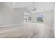 Bright, open living room with vaulted ceilings, light wood floors, and a sliding door to the backyard at 1900 Blue Bird Rd., Loris, SC 29569