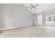 Spacious living room with vaulted ceiling, light-colored floors, and double glass doors at 1900 Blue Bird Rd., Loris, SC 29569