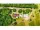 Aerial view of a wooded acreage featuring a home with a long drive and a large barn at 1961 Bright Rd., Little River, SC 29566