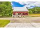 Charming red barn with a white fence and ample parking space, perfect for a workshop or storage at 1961 Bright Rd., Little River, SC 29566