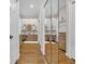 Bathroom with double vanity, hardwood floors, mirrors, and recessed lighting at 1961 Bright Rd., Little River, SC 29566