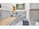 Bathroom with marble tile floors, marble tub, wood countertop and faucet, and window at 1961 Bright Rd., Little River, SC 29566