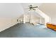 Large bonus room with neutral carpet, featuring a ceiling fan and storage space, ready for customization at 1961 Bright Rd., Little River, SC 29566