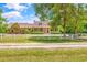 Charming brick home featuring a welcoming front porch and a manicured lawn with a white fence at 1961 Bright Rd., Little River, SC 29566