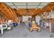 Spacious garage featuring wood construction, stairs to a loft, storage shelving, and space for equipment at 1961 Bright Rd., Little River, SC 29566