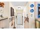 Hallway with tile flooring, white walls, decorative plates, and an exit door at 1961 Bright Rd., Little River, SC 29566