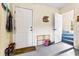 Functional mudroom features storage, a door to the outside, and access to the blue carpeted staircase at 1961 Bright Rd., Little River, SC 29566