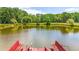 Scenic view of a serene pond and a small wooden deck with a ladder for easy access to the water at 1961 Bright Rd., Little River, SC 29566