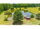 Aerial view of the pond, accented by mature trees and a red gazebo at 1961 Bright Rd., Little River, SC 29566