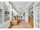 Bright sunroom with hardwood floors, large windows, and comfortable rocking chairs at 1961 Bright Rd., Little River, SC 29566