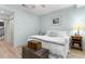 Cozy bedroom with light blue walls, a wood floor, and ceiling fan at 1969 Governors Landing Rd. # 224, Murrells Inlet, SC 29576