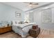 Well-lit bedroom with queen bed, wood flooring, and a ceiling fan at 1969 Governors Landing Rd. # 224, Murrells Inlet, SC 29576
