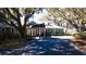 Beautiful entrance to a building with mature shade trees draped in moss and lush landscaping at 1969 Governors Landing Rd. # 224, Murrells Inlet, SC 29576