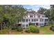 Expansive exterior view of the rear of this home showing its multi-story layout and lush landscaping at 1969 Governors Landing Rd. # 224, Murrells Inlet, SC 29576