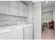 Functional laundry room with washer, dryer, and shelving, conveniently located near living space at 1969 Governors Landing Rd. # 224, Murrells Inlet, SC 29576