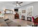 Comfortable living room with a ceiling fan, fireplace, and ample natural light at 1969 Governors Landing Rd. # 224, Murrells Inlet, SC 29576