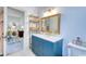 Bathroom featuring a sleek vanity, white countertop, blue cabinetry and view of adjoining room at 203 Broad St., Georgetown, SC 29440