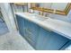 Bathroom close-up featuring blue vanity with white countertop and gold accents over mosaic tile floor at 203 Broad St., Georgetown, SC 29440