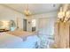 Bedroom with statement lighting, neutral colors and furnishings and access to adjoining bath at 203 Broad St., Georgetown, SC 29440
