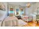 Bright bedroom with hardwood floors and twin beds featuring natural light, pelican themed art and statement lighting at 203 Broad St., Georgetown, SC 29440