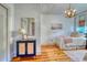 Bright bedroom featuring hardwood floors, statement lighting, and view of bureau and twin bed at 203 Broad St., Georgetown, SC 29440