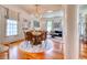 Spacious dining room with hardwood floors, elegant chandelier, and a view into the living room at 203 Broad St., Georgetown, SC 29440