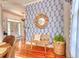 Bright entryway with stylish wallpaper, wood flooring, and decorative mirror at 203 Broad St., Georgetown, SC 29440