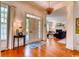 Welcoming foyer with hardwood floors, elegant lighting, and a view into the living room at 203 Broad St., Georgetown, SC 29440