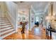 Open foyer featuring hardwood floors, staircase, and a view into the adjacent dining and living spaces at 203 Broad St., Georgetown, SC 29440