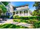 Charming two-story home featuring a covered porch, manicured landscaping, and a well-maintained lawn at 203 Broad St., Georgetown, SC 29440