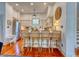 The kitchen features a breakfast bar with seating for four, stainless steel appliances, and light colored cabinetry at 203 Broad St., Georgetown, SC 29440