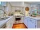 A well lit kitchen featuring stainless steel appliances, marble countertops, and beautiful wooden floors at 203 Broad St., Georgetown, SC 29440
