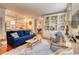 Bright and airy living room with built-in shelving and a view into the dining area and kitchen at 203 Broad St., Georgetown, SC 29440