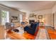A large, open living room featuring hardwood floors, fireplace, neutral colored walls, and comfortable seating at 203 Broad St., Georgetown, SC 29440