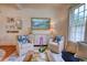 The living room features a cream colored cabinet, two armchairs, blue patterned pillows, and hardwood floors at 203 Broad St., Georgetown, SC 29440