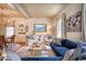 The bright, open concept living room features a dining table, cream colored cabinet, and beautiful hardwood floors at 203 Broad St., Georgetown, SC 29440